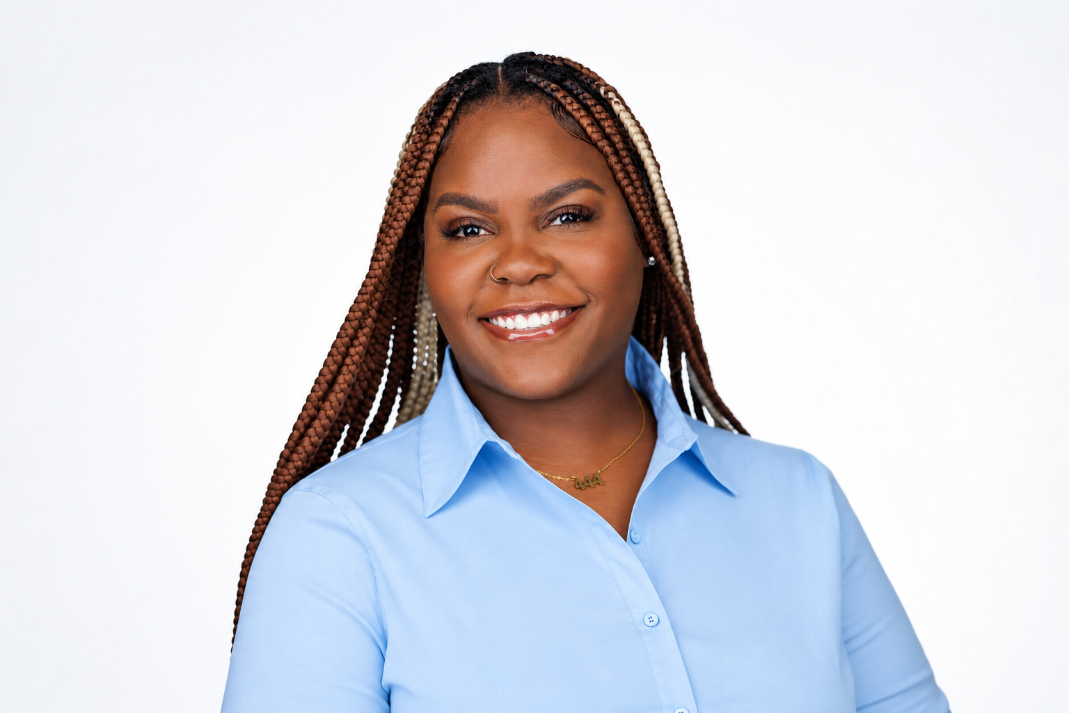 Talia N. Harris, founder of LevelUp, smiling in a light blue shirt